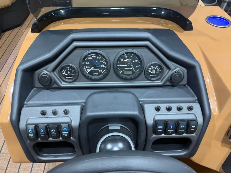 Slide: The Image of The image shows the dashboard of a Bentley Pontoons Legacy 220 Swingback with various gauges and switches. - 13
