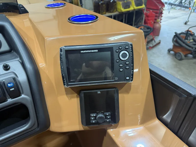 Slide: The Image of The image shows a boat dashboard with a Humminbird fish finder and blue cup holders. - 14