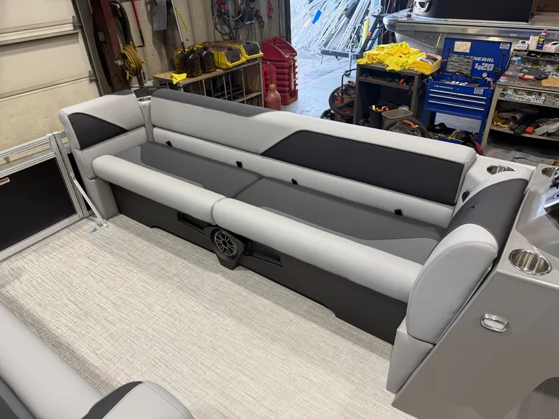 Slide: The Image of The image shows a gray and black bench seat in a boat, surrounded by workshop tools. - 27
