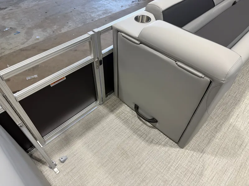 Slide: The Image of The image shows a gray bench seat with a cup holder and a metal gate on a boat. - 24