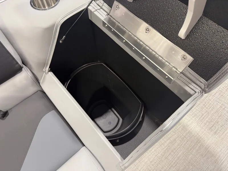 Slide: The Image of An open storage compartment on a boat with a black container inside. - 23