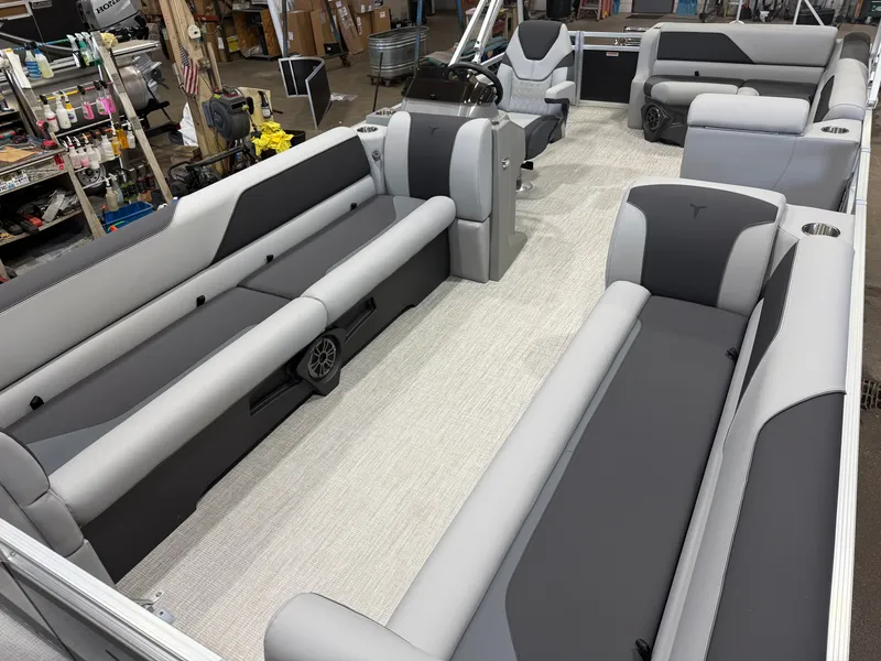 Slide: The Image of The image shows the interior of a Tahoe Sport 2380 Cruise Rear Bench (CRB) boat. It features gray and black upholstered benches and a central helm. - 30