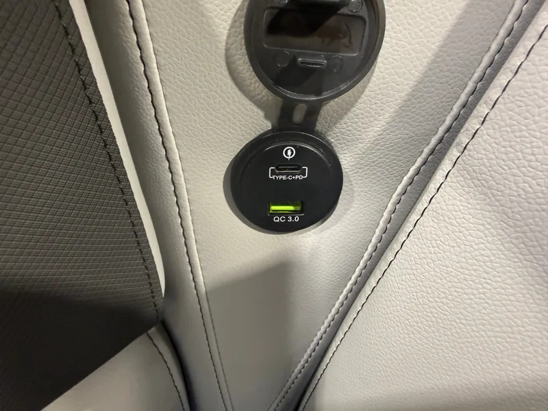 Slide: The Image of Close-up of a USB charging port in a boat with gray upholstery. - 28