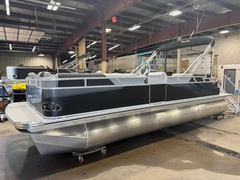 Slide: The Image of A modern pontoon boat with a black hull and silver pontoons is in a warehouse. - 34