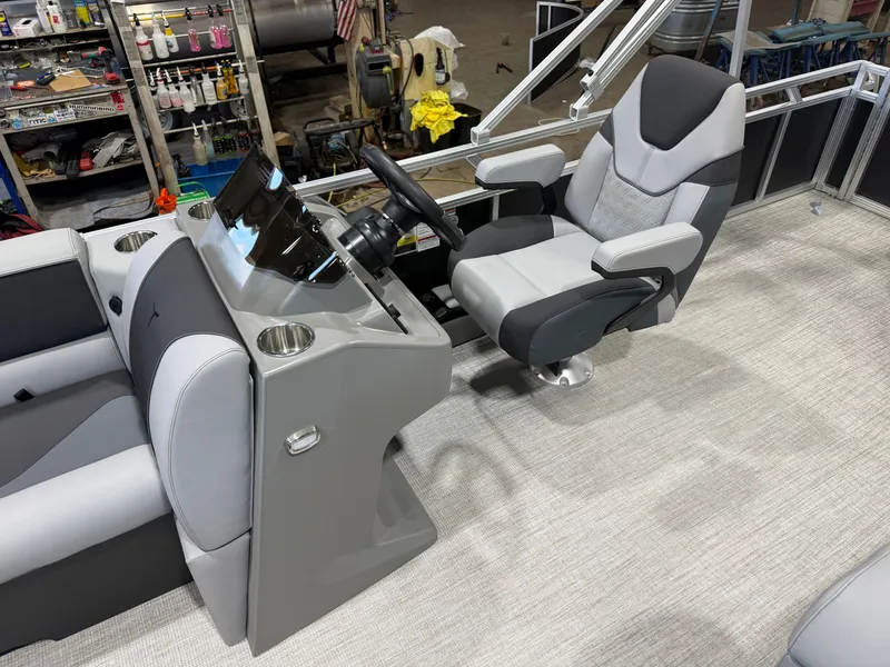 Slide: The Image of The image shows the helm of a modern boat with a gray and black captain's chair. - 9