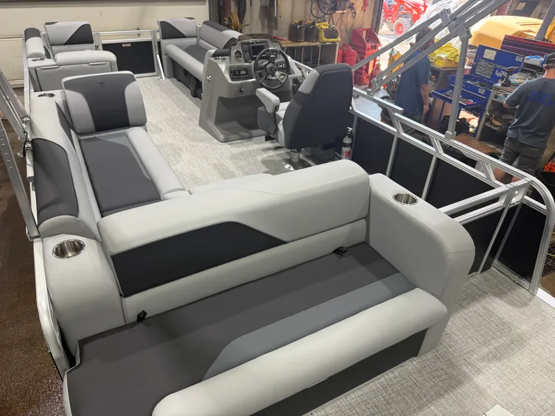 Slide: The Image of Interior view of a modern pontoon boat with gray and black seating and a helm station. - 18