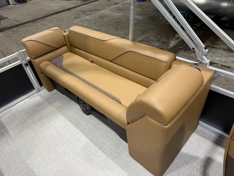 Slide: The Image of The image shows a luxurious beige upholstered bench seat on a boat, surrounded by metal railings. - 18
