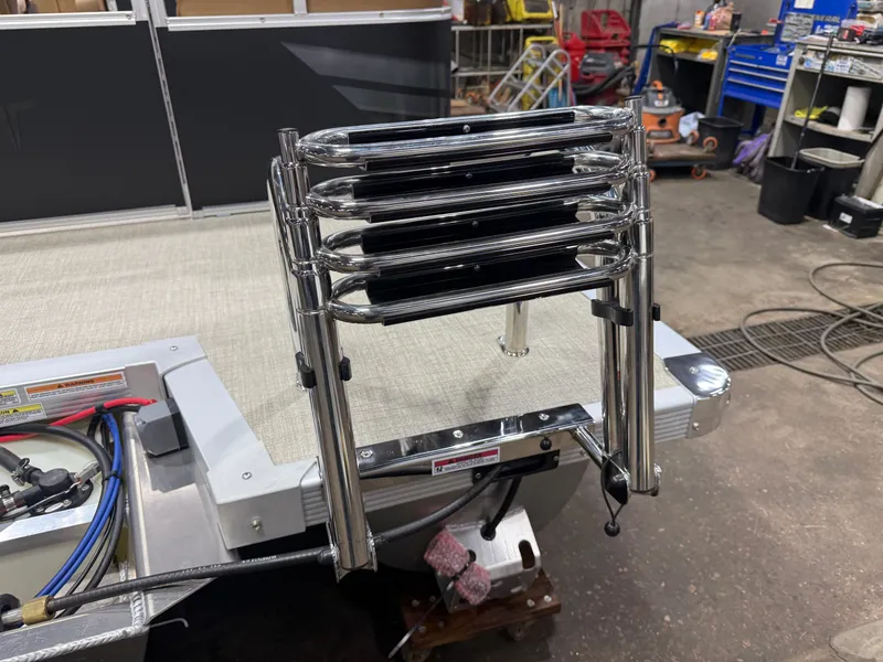 Slide: The Image of A retractable stainless steel swim ladder is mounted at the rear of a boat. - 38
