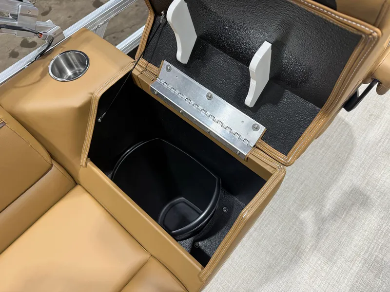 Slide: The Image of A brown seat with built-in storage and a cup holder. - 26