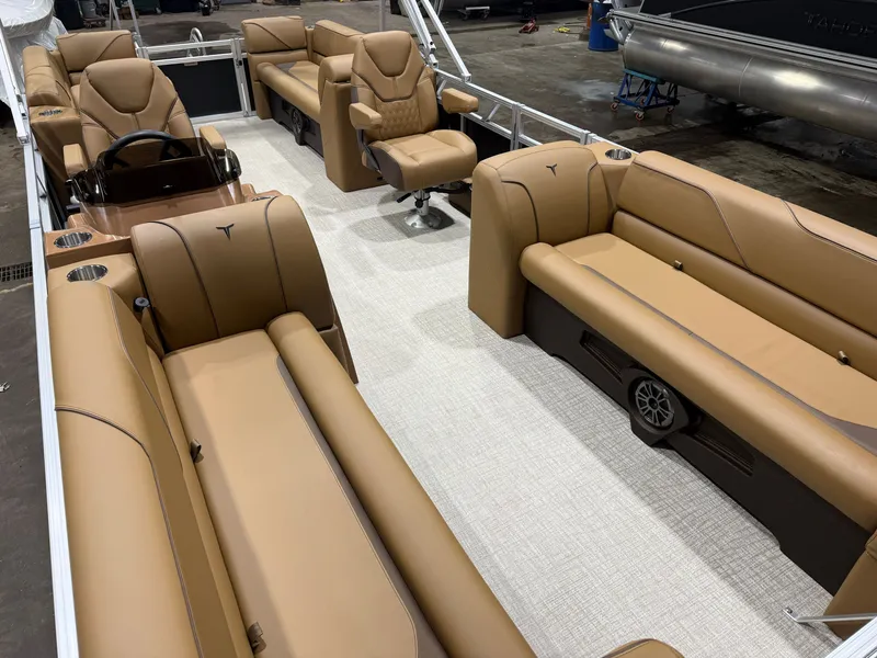 Slide: The Image of The image shows the interior of a Tahoe Sport 2380 Quad Lounge boat with beige leather seating. - 29