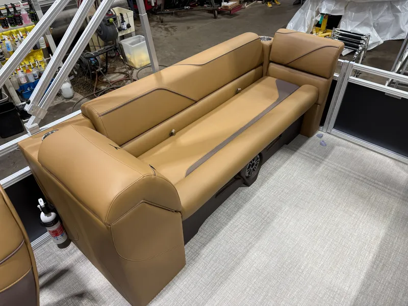 Slide: The Image of The image shows a brown leather bench seat on a boat with light carpet flooring. - 19