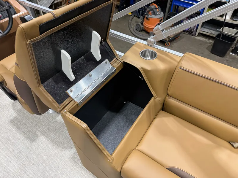 Slide: The Image of Interior view of a boat with brown leather seats and an open storage compartment. - 44