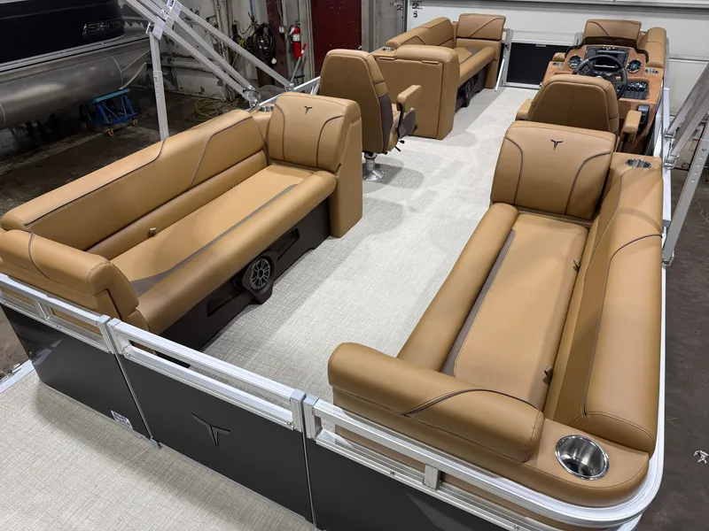 Slide: The Image of Interior of a 2027 Tahoe Sport 2380 Quad Lounge with beige leather seating and helm console. - 20