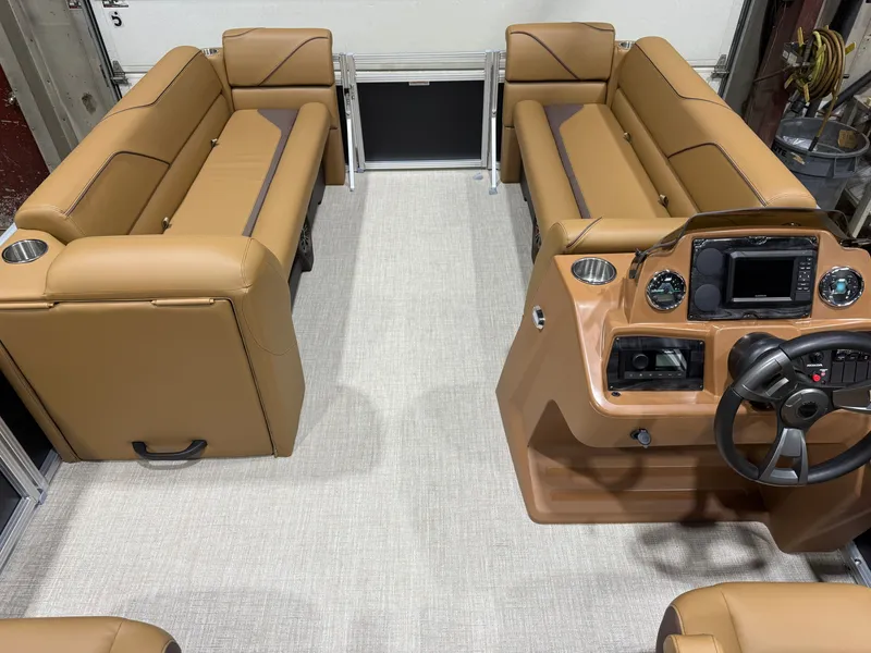 Slide: The Image of Interior of a Tahoe Sport 2380 Quad Lounge with brown leather seating and a modern helm station. - 25