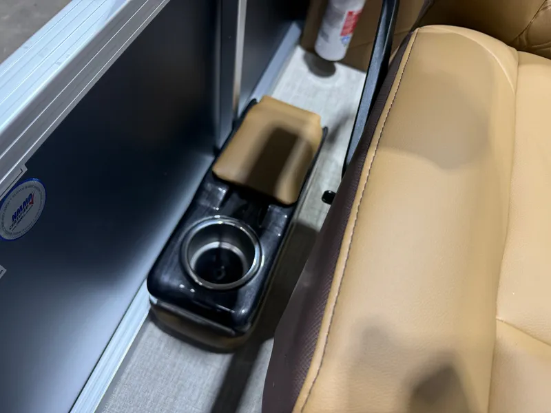 Slide: The Image of Close-up of a boat interior with beige upholstery and a cup holder. - 16