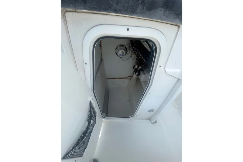 Slide: The Image of Interior view of a 2018 Sea Hunt BX25FS boat compartment with wiring. - 22