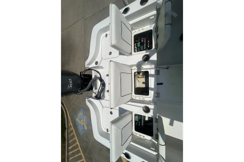 Slide: The Image of 2018 Sea Hunt BX25FS boat deck with open storage compartments and Yamaha 300 engine. - 27