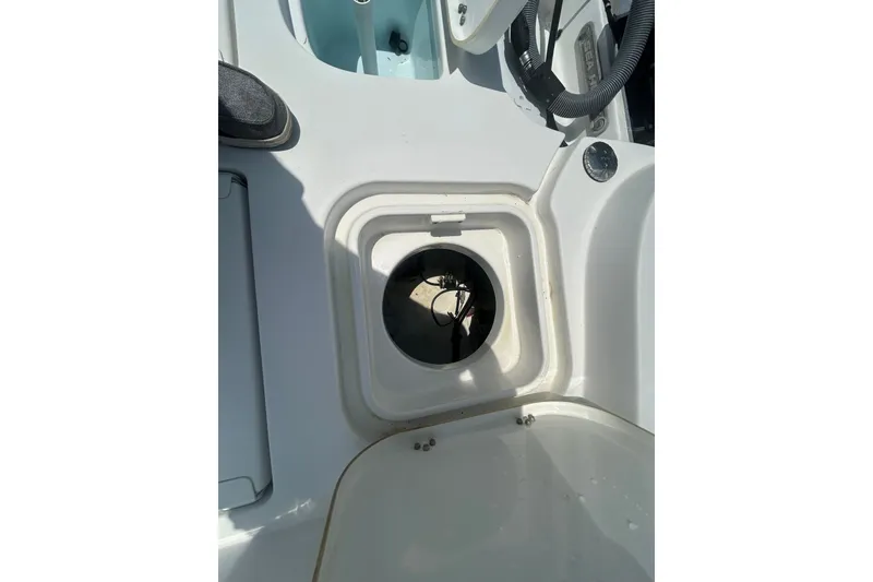 Slide: The Image of 2018 Sea Hunt BX25FS boat interior compartment with open hatch. - 23