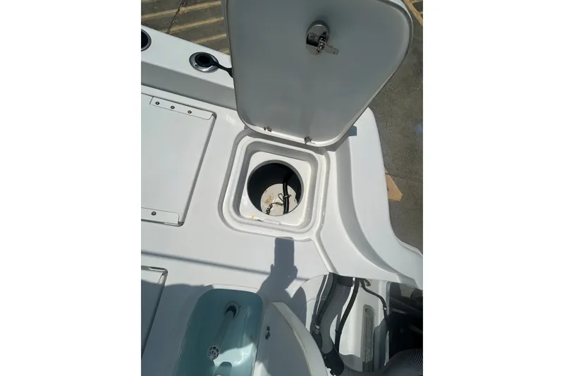 Slide: The Image of 2018 Sea Hunt BX25FS boat storage compartment with open hatch. - 26