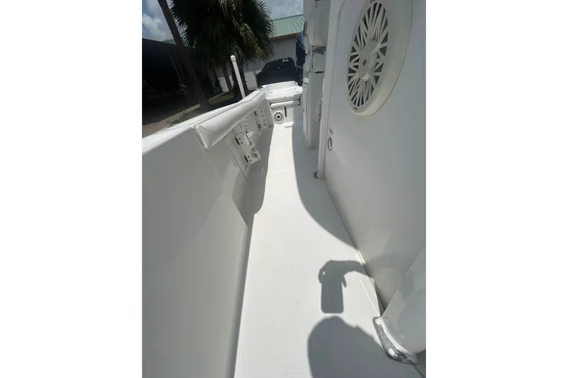 Slide: The Image of 2018 Sea Hunt BX25FS boat interior with white seating and speaker detail. - 20