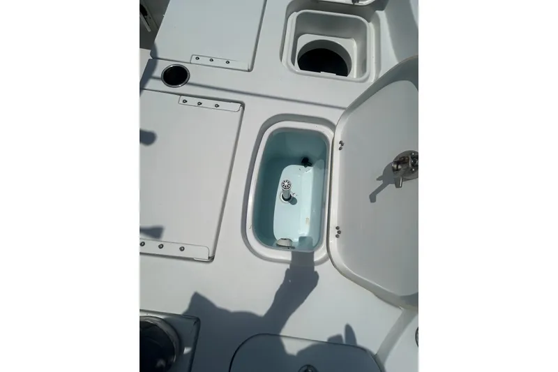 Slide: The Image of 2018 Sea Hunt BX25FS boat deck with open storage compartments. - 24