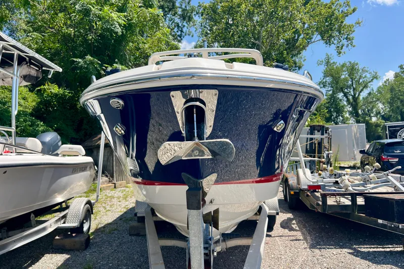 Slide: The Image of 2020 Chaparral 277 SSX boat on trailer, surrounded by trees and other boats. - 3