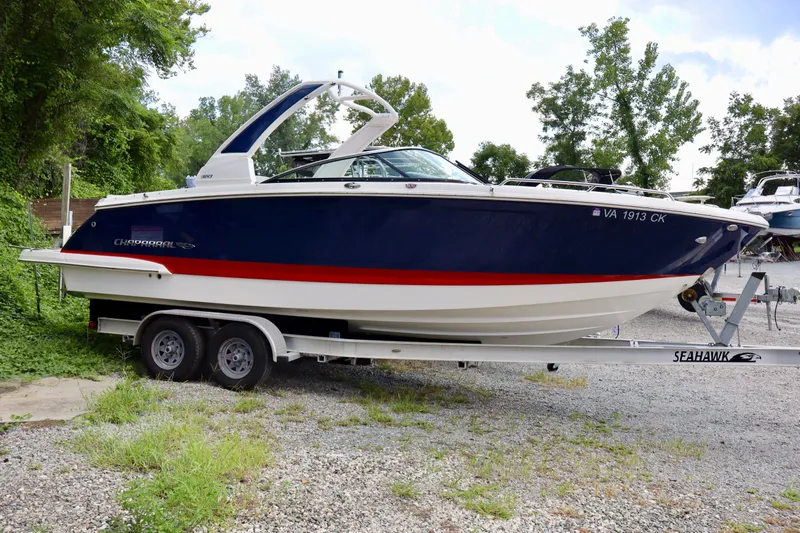 The Image of 2020 Chaparral 277 SSX boat on trailer, parked outdoors with trees in background. - 0