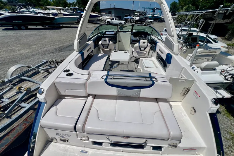 Slide: The Image of 2020 Chaparral 277 SSX boat interior with white seating and modern dashboard. - 9