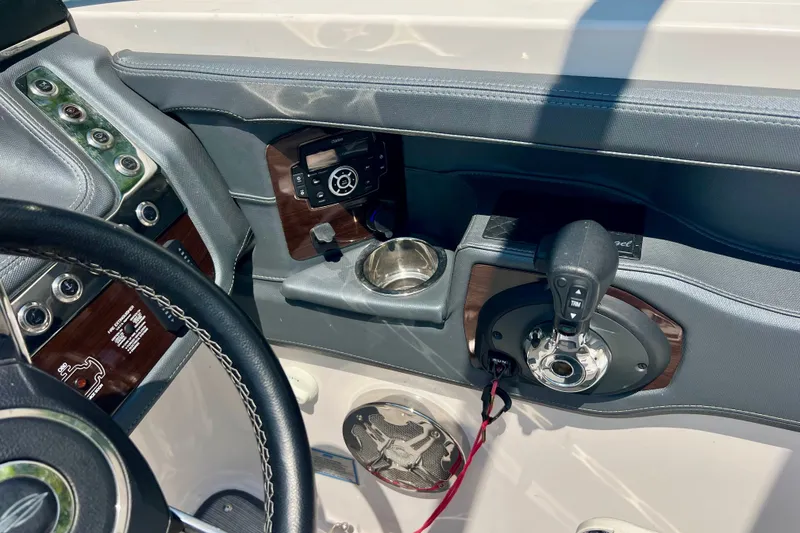 Slide: The Image of 2020 Chaparral 277 SSX boat dashboard with steering wheel and control panel. - 17