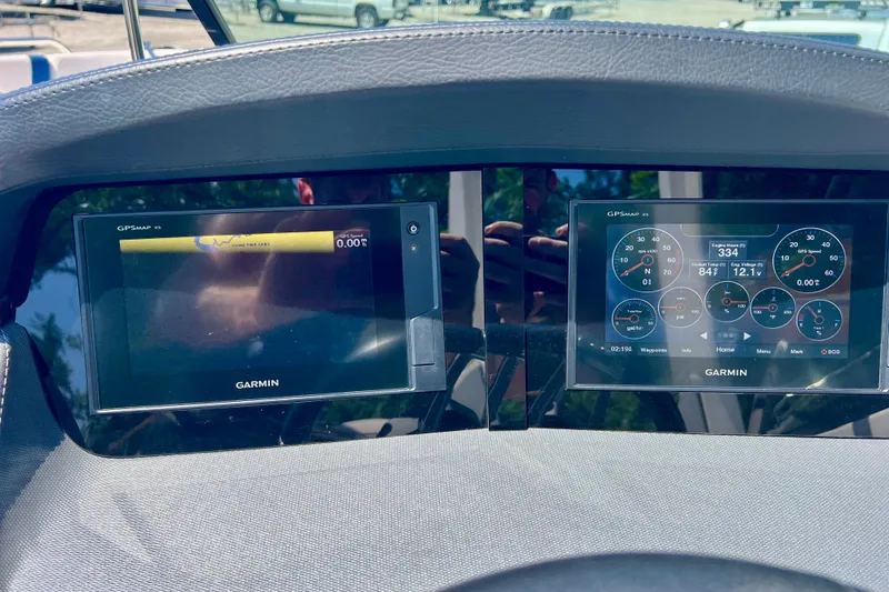 Slide: The Image of Dashboard of a 2020 Chaparral 277 SSX boat featuring Garmin GPS displays. - 16