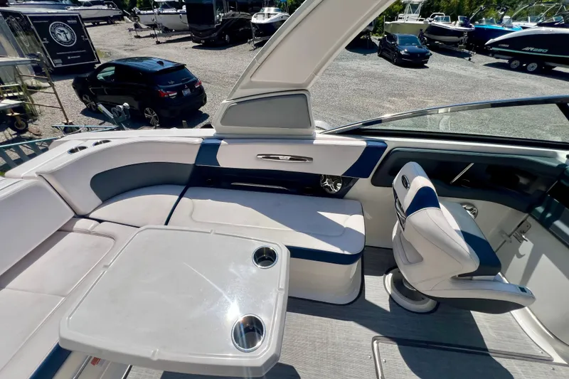 Slide: The Image of 2020 Chaparral 277 SSX boat interior with seating and table, showcasing luxury design. - 12