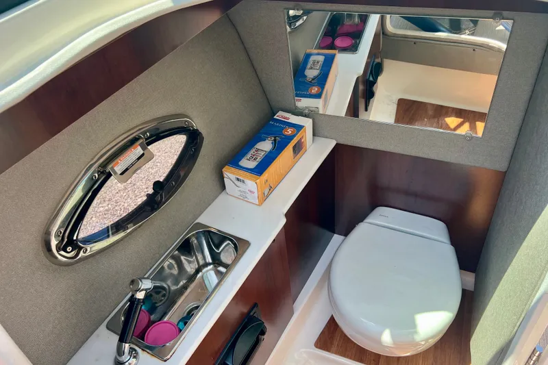 Slide: The Image of 2020 Chaparral 277 SSX boat interior with sink, toilet, and mirror. - 23