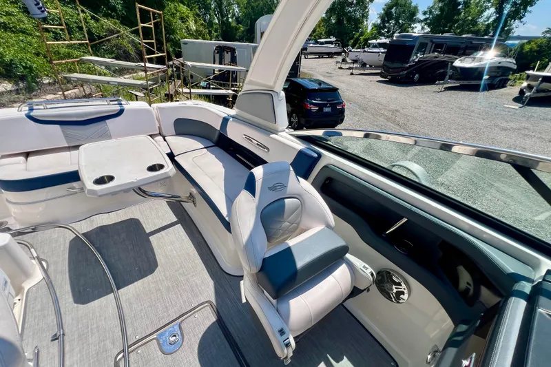 Slide: The Image of Interior of 2020 Chaparral 277 SSX boat with seating and table, parked outdoors. - 11