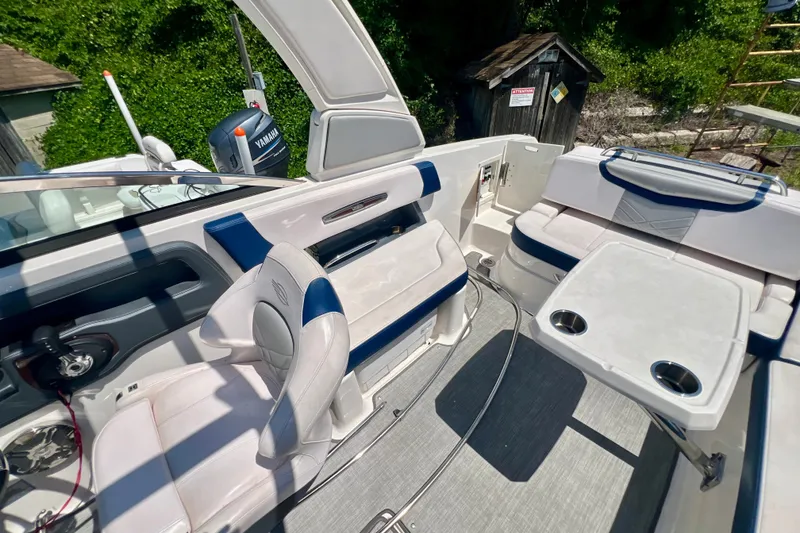 Slide: The Image of 2020 Chaparral 277 SSX boat interior with seating and table, featuring Yamaha engine. - 14