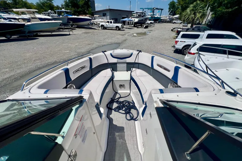 Slide: The Image of 2020 Chaparral 277 SSX boat interior with seating, docked among other boats. - 18