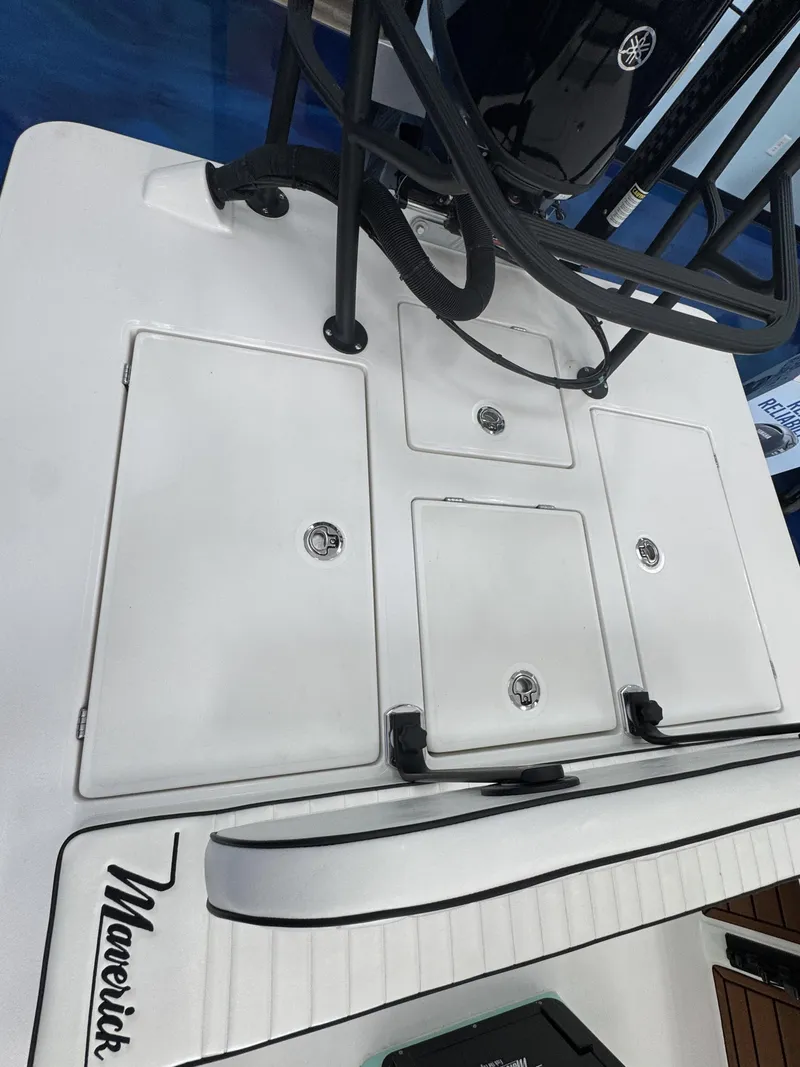 Slide: The Image of The image shows the deck of a 2027 Maverick 18 HPX-V boat with multiple storage compartments. - 19