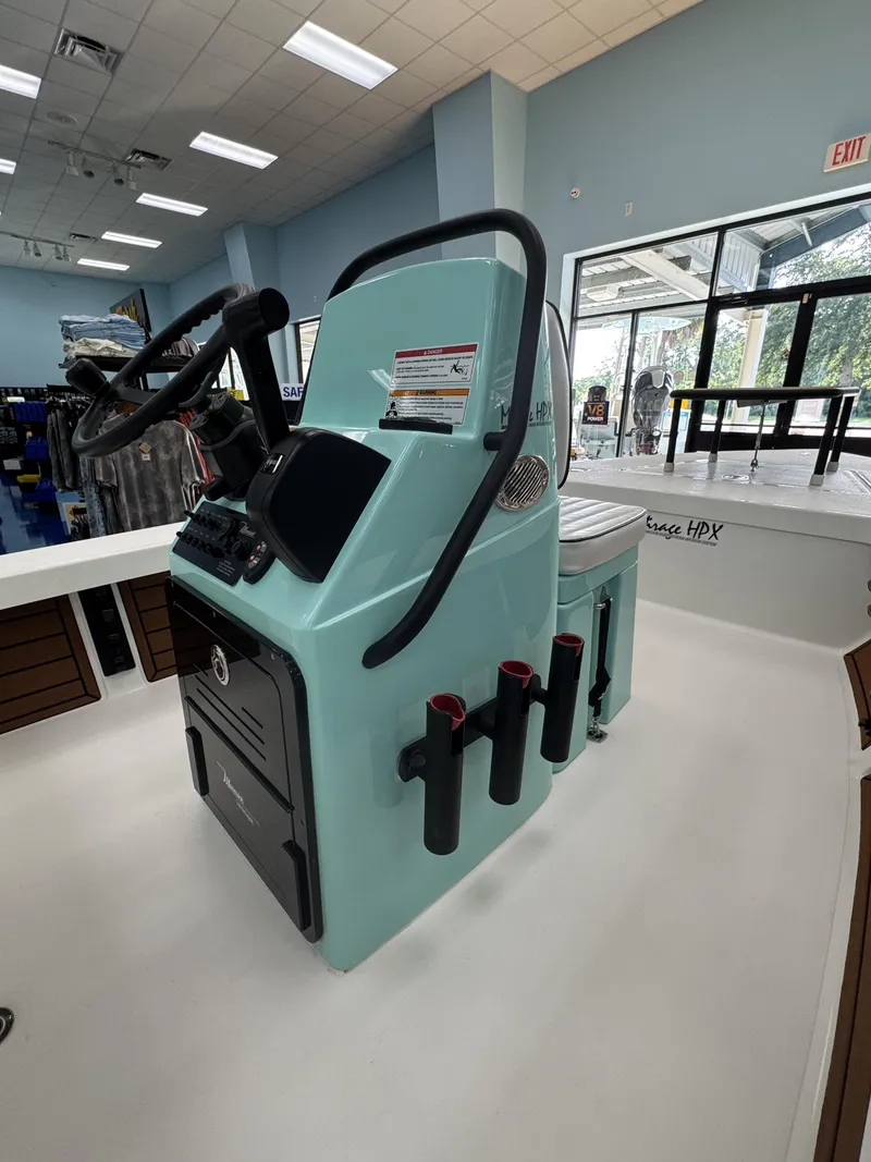 Slide: The Image of The image shows the cockpit of a 2027 Maverick 18 HPX-V boat with controls and rod holders. - 31