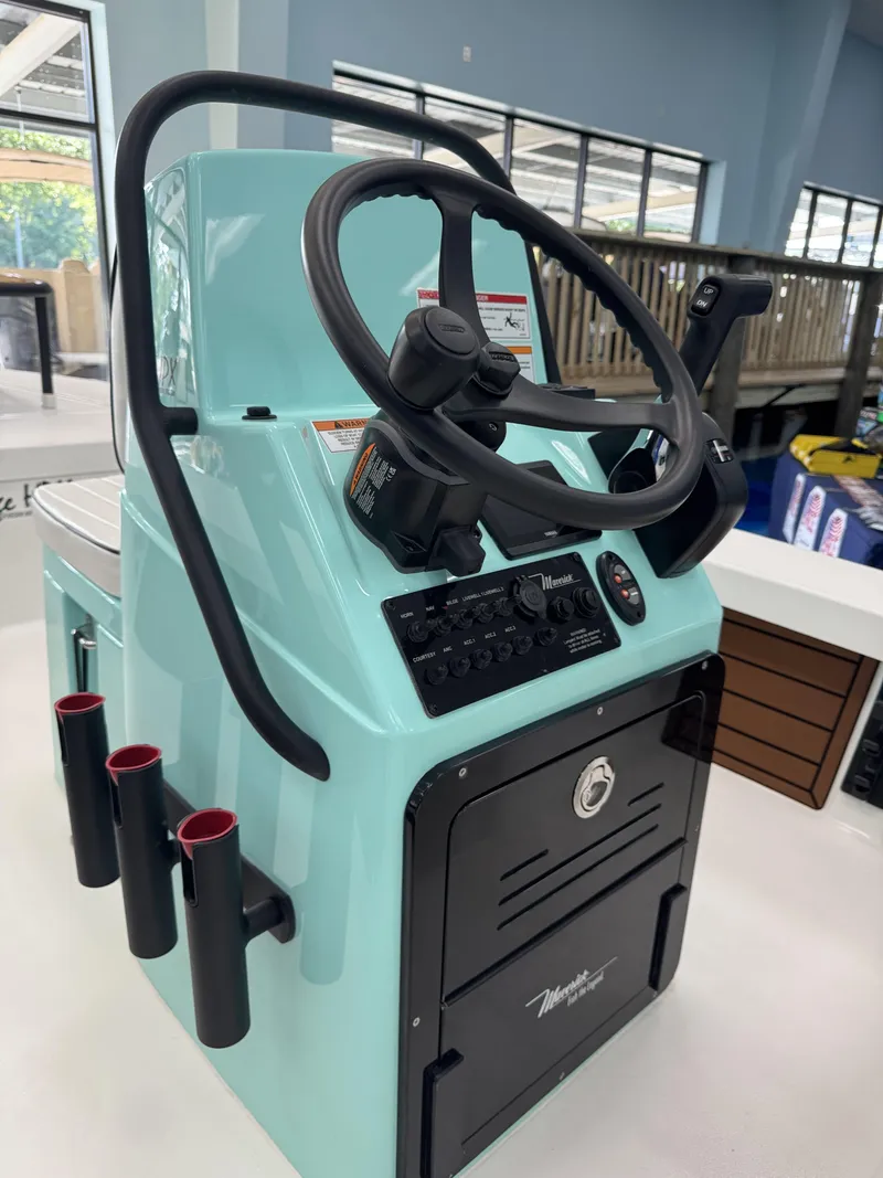 Slide: The Image of The image shows the helm of a 2027 Maverick 18 HPX-V boat in a light blue color. - 22
