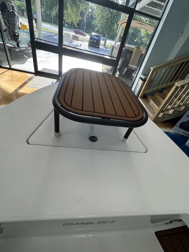 Slide: The Image of The image shows the deck of a 2027 Maverick 18 HPX-V boat with a raised seating area. - 33