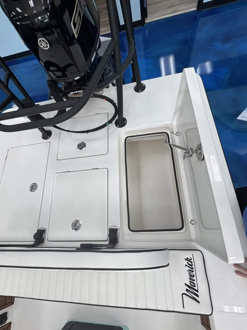 Slide: The Image of The image shows the deck of a Maverick 18 HPX-V boat with storage compartments and a motor. - 28