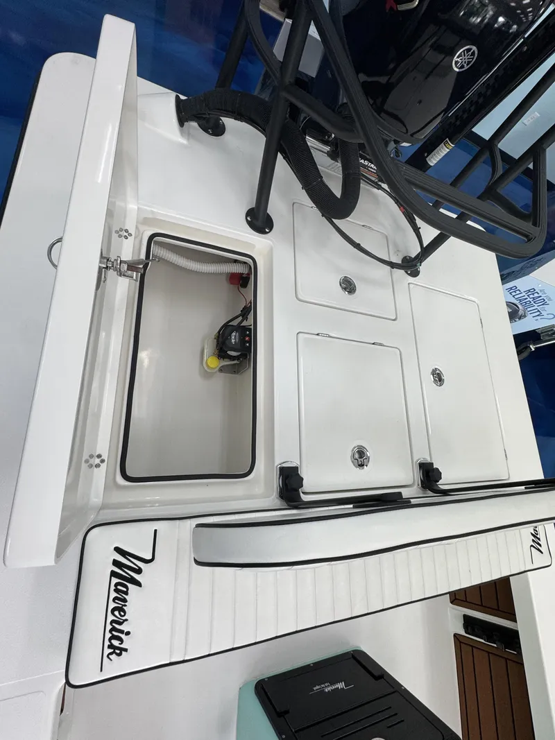 Slide: The Image of The image shows the deck of a Maverick 18 HPX-V boat with storage compartments and a Yamaha engine. - 30