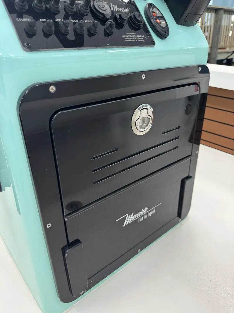 Slide: The Image of A turquoise helm station with black controls and Maverick logo. Sleek design. - 24