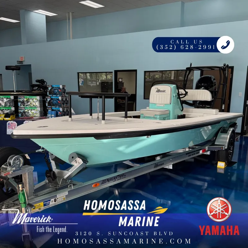 The Image of A 2027 Maverick 18 HPX-V boat on a trailer in a showroom. It features a turquoise exterior. - 1