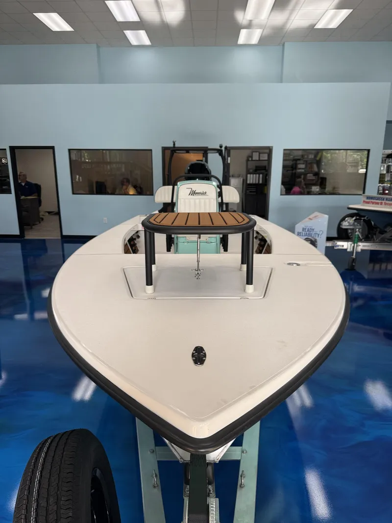 Slide: The Image of A 2027 Maverick 18 HPX-V boat is displayed in a showroom with a blue floor. - 16