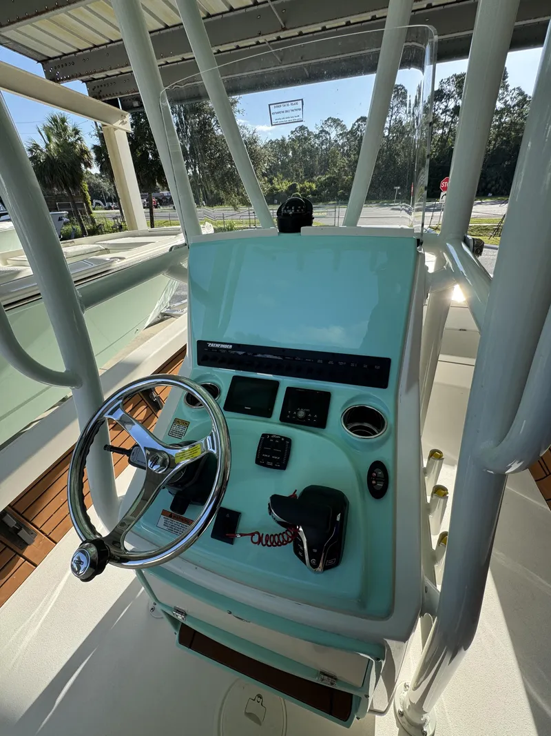 Slide: The Image of The image shows the helm of a 2027 Pathfinder 2500 Tournament boat with a modern steering wheel and instruments. - 39