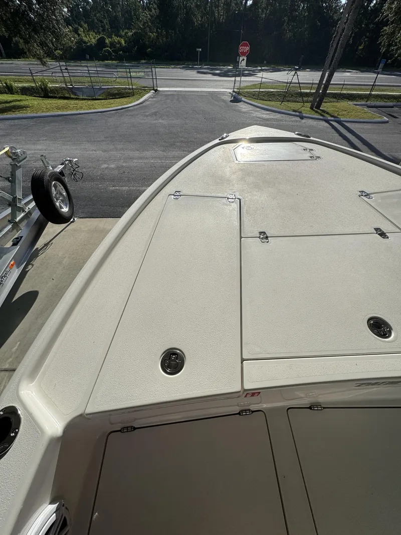 Slide: The Image of The boat features a spacious deck with multiple storage compartments, parked on a trailer. - 19