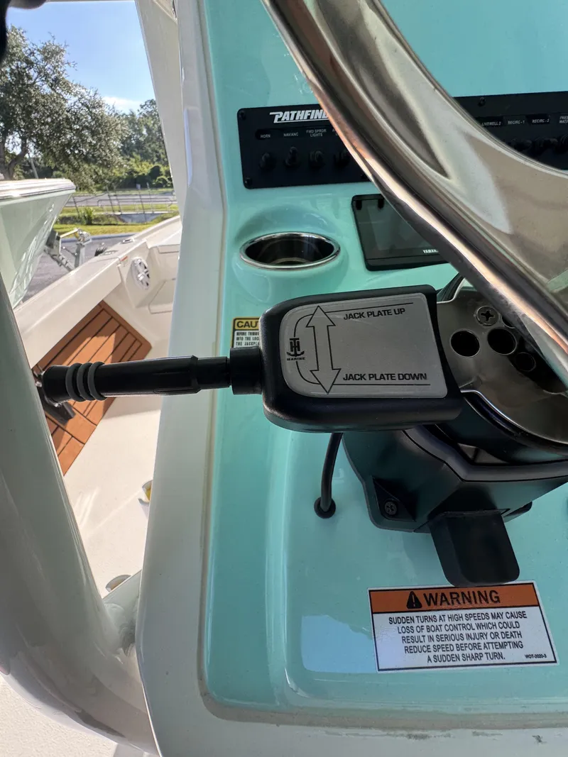 Slide: The Image of Close-up of the control area on a Pathfinder 2500 Tournament boat with a lever and warning label. - 40