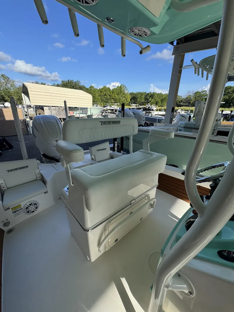 Slide: The Image of The image shows the cockpit of a 2027 Pathfinder 2500 Tournament boat with seating and rod holders. - 32