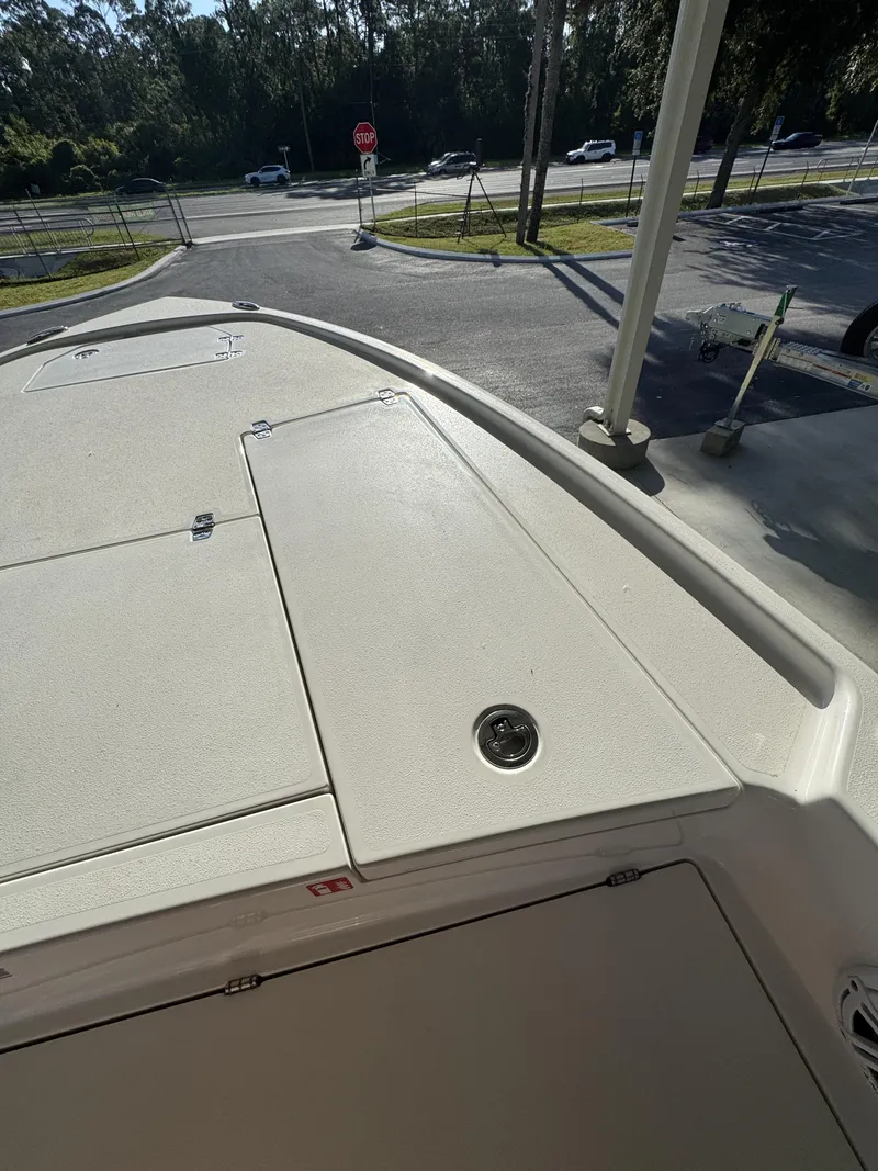 Slide: The Image of The image shows the deck of a 2027 Pathfinder 2500 Tournament boat parked in a lot. - 23