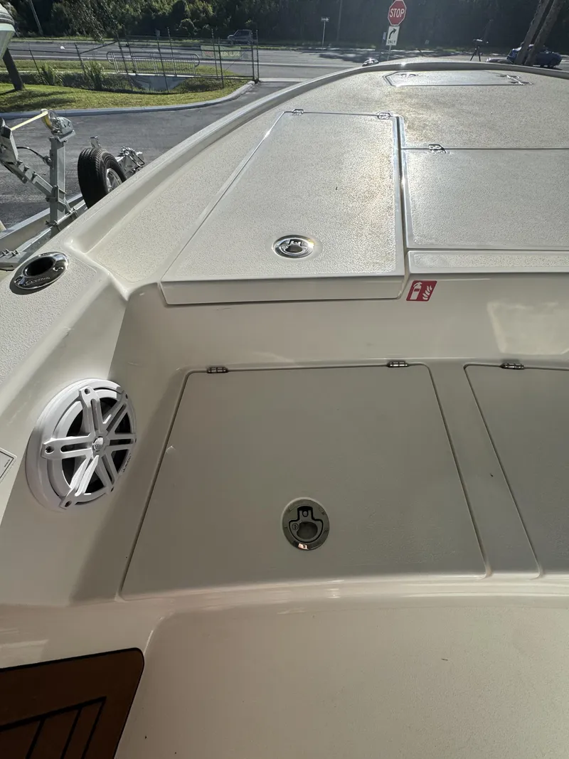 Slide: The Image of The image shows the deck of a 2027 Pathfinder 2500 Tournament boat with storage hatches and a speaker. - 25